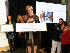 Supplied photo
Standing at the podium is Culture, Tourism and Sports Minister Eleanor McMahon, while artistic director Joe Osawabine, in surprise, is hugging Margery Trudeau, president of theb of directors for the Debajehmujig Storytellers Group.