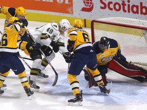 Max Jones draws a crowd as he tries to jam the puck past Erie's Daniel Murphy in the first period of their game Sunday at Budweiser Gardens. Erie's Ryan Martin, Alex Gritz and Jordan Sambrook converge on the play. (MIKE HENSEN, The London Free Press)