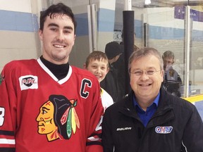 Mitchell Hawks’ captain Mackinnon Hawkins (left) received the award for the PJHL Pollock Division Defenceman of the Month for November from league convenor Steve Coulter before their Dec. 2 home game. SUBMITTED