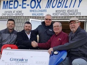 Committee members Adam Moore, Trevor Bazinet, Down Edward and Myles Murdock accept a $10,000 donation from Doug Fines (second from right). (Contributed photo)