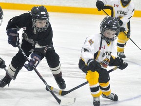 Blake Otten (right), a defenceman with the Mitchell Novice LL 2 team, finds his stick twisted behind him as he tries to go after the puck during action against visiting Blyth-Brussels this past Sunday, Dec. 10. The Meteors defeated their visitors, 10-2. ANDY BADER/MITCHELL ADVOCATE