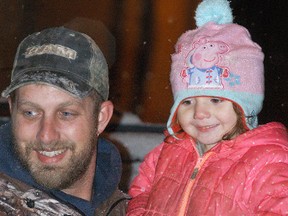 Dover Centre's Nick Lunn holds his daughter Kyra Lunn at the Dresden Santa Claus parade on Saturday so she can get a better view. Along with the parade, a night market brought a lot of foot traffic to Dresden's downtown on Saturday evening.