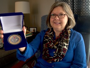 Susan Huson displays her Diabetes Half Century Award, presented by St. Joseph’s Health Care to her and 23 others this year. The award recognizes patients who have managed diabetes for 50 years, which is also a testament to modern advances in treatment. (CHRIS MONTANINI\LONDONER\POSTMEDIA NETWORK)