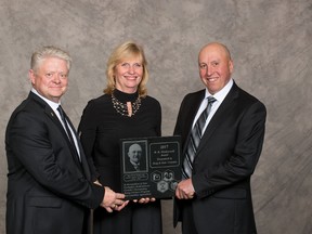 Canada's Outstanding Young Farmer Program president Carl Marquis with Doug and Joan Cranston.