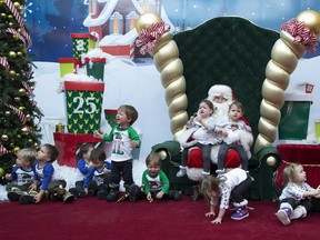Santa Claus greets five sets of twins, whose ages range from 23-25 months, prior to a chaotic photo shoot at White Oaks Mall in London, Ont. on Wednesday December 13, 2017. The children are Leo and Alex Mihaljevic, Carter and Caiden Carmichael, Austin and Mason Dunlap-Gray, Katrina and Victoria Hale, and Lexi and Ashlyn Fedorow. The moms and tots meet socially once a month. (DEREK RUTTAN, The London Free Press)