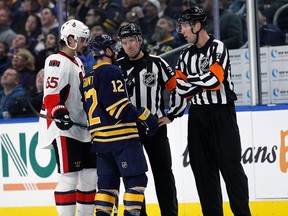 Brian Gionta of the Buffalo Sabres and Erik Karlsson of the Ottawa Senators talk with referee Eric Furlatt #27 and referee Kendrick Nicholson, of Milverton, during the second period at the KeyBank Center on Nov. 9, 2016 in Buffalo. (Kevin Hoffman/Getty Images)