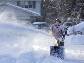Wayne Smith uses his snowblower on his west end London street. He says he cleans the road regularly to help snow plow operators navigate the narrow cul-de-sac. Another dusting of snow is expected today, amounting to a couple of centimetres. (DEREK RUTTAN, The London Free Press)