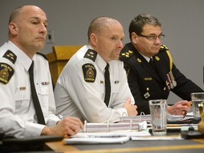 Deputy chiefs Daryl Longworth, Steve Williams, and London Police Chief John Pare listen to a report at the police services board meeting. A motion was passed Thursday to hold the monthly meetings at city hall beginning in January. (Free Press file photo)