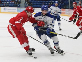 Doug Blaisdell, right, of the Sudbury Wolves, and Anthony Demeo, of the Soo Greyhounds, battle for the puck during OHL action at the Sudbury Community Arena in Sudbury, Ont. on Friday November 17, 2017. John Lappa/Sudbury Star/Postmedia Network