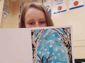 Grade 8 County Central student Anna Lundgren looks over Palliser Regional Schools’ greeting card, which features her artwork. Photo courtesy of Palliser Regional Schools