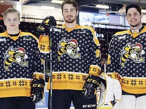 Drake Rymsha, left, Connor Schlichting and Justin Fazio wear the jerseys the Sarnia Sting will don for their third annual ugly Christmas sweater night against the Flint Firebirds at Progressive Auto Sales Arena on Saturday, Dec. 16, 2017. (Contributed Photo)