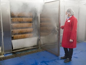 Food safety co-ordinator Pawel Zwerello opens the door of a smoke house at Sikorski Sausage in London, Ont. (Free Press file photo)