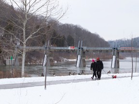 Pedestrians walk along a path near the Springbank Dam in Springbank Park in London, Ont. on Thursday January 28, 2016. (Free Press file photo)