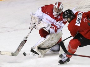 Denmark goaltender Emil Gransoe shoots the puck away from Canada?s Alex Formenton during a world junior exhibition game Friday in St. Catharines. Canada won 5-2. (Peter Power/ THE CANADIAN PRESS)