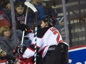 USports' Randy Gazolla (22) takes out Canada's Victor Mete (2) during third period exhibition hockey action in preparation for the upcoming IIHF World Junior Championships in St. Catharines, Ont., on Thursday, December 14, 2017. (THE CANADIAN PRESS/Nathan Denette)