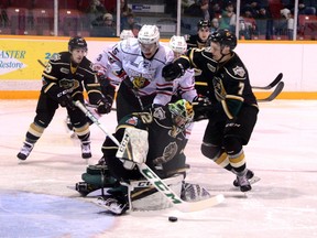 Owen Sound forward Matthew Struthers and London Knights defenceman Shane Collins battle in front of Knights goalie Jospeh Raaymakers during the Knights? 1-0 win over the Attack Sunday in Owen Sound. (Greg Cowan/Postmedia News)