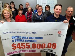 United Way Hastings and Prince Edward executive director Kathy Murphy, far left, and Procter and Gamble Belleville plant manager Joe Folk, second from right, display the company's 2017 donation to the charity Monday at the plant in Belleville. Employees raised $455,000. Behind Murphy and Folk stand some of their respective employees.