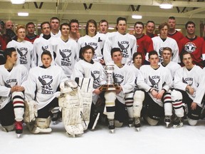 The County Central High School (CCHS) students in the hockey program played a game against a team, Guns ’N’ Hoses, made up of local firefighters and RCMP officers Dec. 12 at the Vulcan District Arena. The proceeds of the hockey game went to the Vulcan pool project, and food and toy donations were given to the Vulcan and Region Food Bank Society. Here, CCHS hockey students team in white, with the Guns ’N’ Hoses team of firefighters and RCMP officers, with coaches Don Monts and Troy Dobson to the left, after the game.