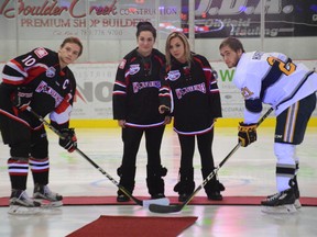 The Whitecourt Wolverines held a memorial hockey game at the Scott Safety Centre on Dec. 16 one year after the deaths of 13-year-old Ryder and 11-year-old Radek MacDougall. Above, Alesha (left) and Shelbey Stark, daughters of Brent Stark and stepsisters of the late brothers, attend the opening ceremony (Peter Shokeir | Whitecourt Star).