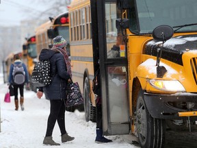 Students from Kingston Collegiate and Module Vanier get on school buses parked on Frontenac Street after school on Monday. (Ian MacAlpine/The Whig-Standard)