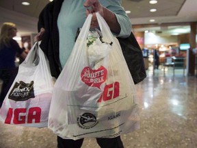 A woman leaves a grocery store Friday, May 15, 2015 in Montreal. THE CANADIAN PRESS/Ryan Remiorz