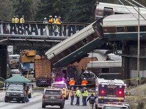 Emegency crews work at the scene of a Amtrak train derailment on December 18, 2017 in DuPont, Washington. (Photo by Stephen Brashear/Getty Images)