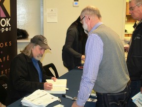 University of Washington professor David Montgomery signs a copy of his latest book, Growing A Revolution, following a presentation on soil degradation and regeneration at Sarnia Arena on Dec. 12.
CARL HNATYSHYN/SARNIA THIS WEEK