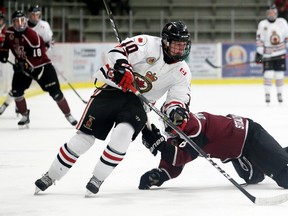 Jon Sanderson (No. 10 in white) skates around a Chatham Maroons defender during Sunday's Jr. 'B' hockey game that saw the Sarnia Legionnaires defeat the Maroons 5-2. Sanderson had three goals in the contest. (MARK MALONE, Postmedia Network)