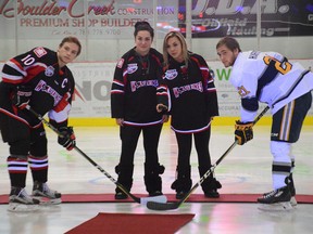 The Whitecourt Wolverines held a memorial hockey game at the Scott Safety Centre in Whitecourt on Dec. 16 one year after the deaths of 13-year-old Ryder and 11-year-old Radek MacDougall. Above, Alesha (left) and Shelbey Stark, daughters of Brent Stark and stepsisters of the late brothers, attend the opening ceremony. - Photo by Peter Shokeir