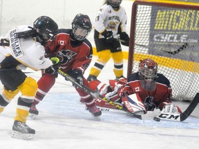 Josie Walker (9) of the Mitchell Atom B girls is thwarted on this prime scoring attempt during action against visiting Stratford last Wednesday, Dec. 13. The teams battled through a 0-0 scoreless tie. ANDY BADER/MITCHELL ADVOCATE