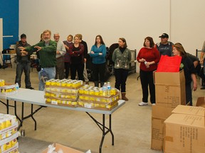 Neil Ainsworth, the logistics co-ordinator of Christmas Hampers, gives all of the volunteers directions on how to pack with the reusable bags, which are new to the hamper campaign this year, at the Frontenac Mall on Tuesday. (Julia McKay/The Whig-Standard)