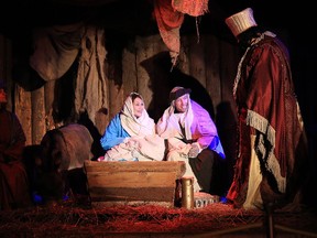 Gino Donato/Sudbury Star/Postmedia Network
Melissa Shaw as Mary, with Stefan Howard as Joseph and Wyatt Howard as baby Jesus, take part in the 30th annual All Nations Church living nativity, which kicked of at Science North on Wednesday. The living nativity takes place at 7:30 p.m. for the remainder of the week, including Christmas Eve, and closes off with a massive fireworks display.