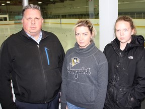 Shawn Allen, president of the South Kent Minor Hockey Association, is shown with Jan Legue, centre, and her daughter Danielle, 10, at the East Kent Memorial Arena in Ridgetown.