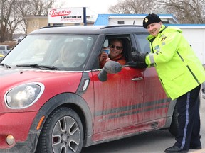 BRUCE BELL/THE INTELLIGENCER
Staff Sgt. John Hatch, detachment commander of Prince Edward County OPP, stops Picton and Wellington Tim Hortons owner Paul Massey during the kickoff to the Quinte Region Traffic Coalition Festive R.I.D.E. program Thursday in Rossmore. As expected, Massey only had coffee in the cup.