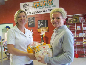 Sisters Monika Williams, left, and Erika McGrail hold turkeys in the retail store at Franz Turkey Farm near Petrolia. They are among the third generation of the Franz family to be involved in the farm that announced this week its retail store will close at the end of this year. Paul Morden/Sarnia Observer/Postmedia Network