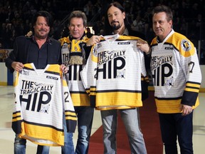 Paul Langlois, Gord Sinclair and Rob Baker of The Tragically Hip received specialized jerseys from Frontenacs General Manager Doug Gilmour before the ceremonial puck-drop at the Kingston Frontenacs verses Mississauga Steelheads Ontario Hockey League game in Kingston, Ont. on Saturday January 28, 2017.  Steph Crosier/Kingston Whig-Standard/Postmedia Network