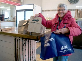 Meals on Wheels London volunteer Anne Baverstock prepares a meal for delivery at the Village Table on Dundas Street last month. (Postmedia Network file photo)