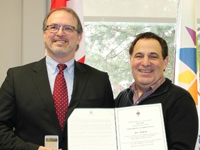 Yves Laliberte, left, principal at Ecole secondaire catholique Champlain, was one 13 recipients of a commemorative Canada 150 pin from Nickel Belt MP Marc Serre on Thursday. Photo supplied