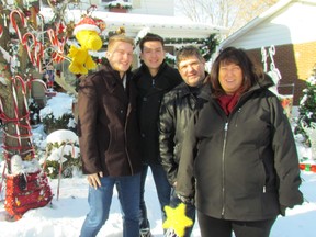 Judges for the Sarnia-Lambton Celebration of Lights named George Laird, 1237 Echo Road, winner of this year's home lighting contest. The prizes were given out just before Christmas. Shown in their winning yard on Echo Road are the Laird family, from left, Nicholas Laird, George Laird, Sandy Laird and Devon Laird. (Paul Morden/Sarnia Observer/Postmedia Network)