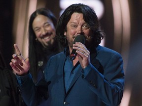Paul Langlois and Rob Baker accept the award for The Tragically Hip winning the award for Group of the Year at the Juno awards show Sunday April 2, 2017 in Ottawa. THE CANADIAN PRESS/Sean Kilpatrick