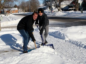 Chatham, Ont. residents Jason King, left, and his son Sawyer King, 17, are among the volunteer snow angels across the region who shovel driveways and sidewalks for the elderly and other people who can't do it themselves. They are seen here on Wednesday December 27, 2017 shoveling the driveway of a home in south Chatham, Ont. (Ellwood Shreve/Chatham Daily News/Postmedia Network)