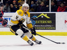 Sarnia Sting's Jordan Ernst (16) drives to the Windsor Spitfires' net while being pursued by Austin McEneny (5) in the first period at Progressive Auto Sales Arena in Sarnia, Ont., on Thursday, Dec. 28, 2017. (MARK MALONE/Postmedia Network)