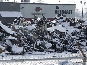 A pile of debris is all that remains of a storage building full of motorcycles, all-terrain vehicles and snowmobiles after a Thursday fire at Hully Gully on Wharncliffe Road South near Wonderland Road in London. Damage could total $2.5 million, one fire official said Friday. (DEREK RUTTAN, The London Free Press)