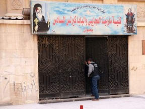 An Egyptian security member inspect the entrance gate of a church south of the capital Cairo, following a gun attack, on December 29, 2017. SAMER ABDALLAH / AFP/Getty Images