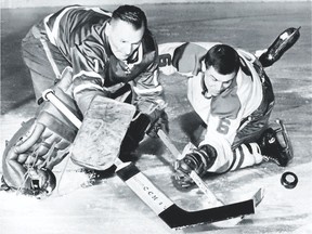 Toronto Maple Leafs goaltender Johnny Bower uses his famous pokecheck to knock the puck away from Montreal Canadiens? forward Ralph Backstrom during a 1964 game. (Postmedia file photo)