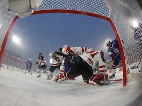 Canada's goaltender Carter Hart makes a save on Adam Fox of the United States during second period IIHF World Junior Championship preliminary round outdoor game action at New Era Field in Orchard Park, N.Y., Friday.
Mark Blinch / The Canadian Press