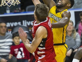 London Lightning?s Kyle Johnson rises over Logan Stutz of the Windsor Express for a basket during the first half of their National Basketball League of Canada game at Budweiser Gardens on Friday night.  Johnson led the Lightning with 30 points in a 129-106 win. (DEREK RUTTAN, The London Free Press)