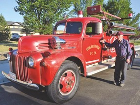 PHOTO COURTESY OF DANA ZIELKE. Oliver Perry stands by the restored Ford three ton 1947 fire truck that was restored as part of the Project 47 initiative.