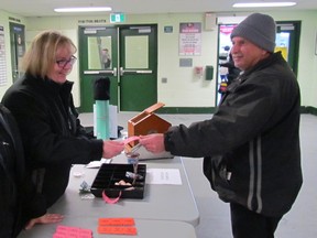 From left, Janice Gould and Karen Young sell 50-50 tickets Saturday to George Meredith in the lobby of the arena in Petrolia during the 50th Annual Earle Trevail Memorial regional midget Silver Stick hockey tournament.
Paul Morden/Sarnia Observer/Postmedia Network