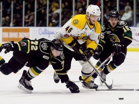Sarnia Sting's Hugo Leufvenius (46) battles London Knights' Alec Regula (72) and Cole Tymkin (15) for the puck in the first period at Progressive Auto Sales Arena in Sarnia, Ont., on Sunday, Dec. 31, 2017. (Mark Malone/Chatham Daily News/Postmedia Network)